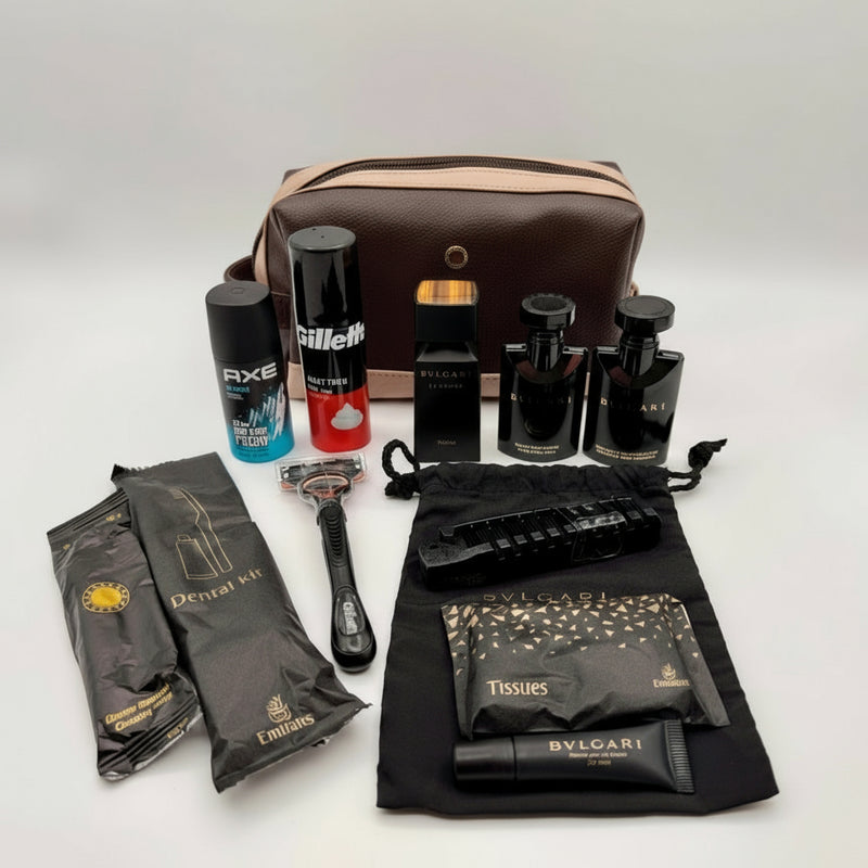 Grooming kit with various items including a bag, bottles, and a razor on a white background